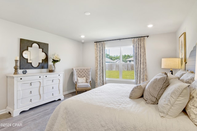 bedroom with recessed lighting, light wood-style flooring, and baseboards