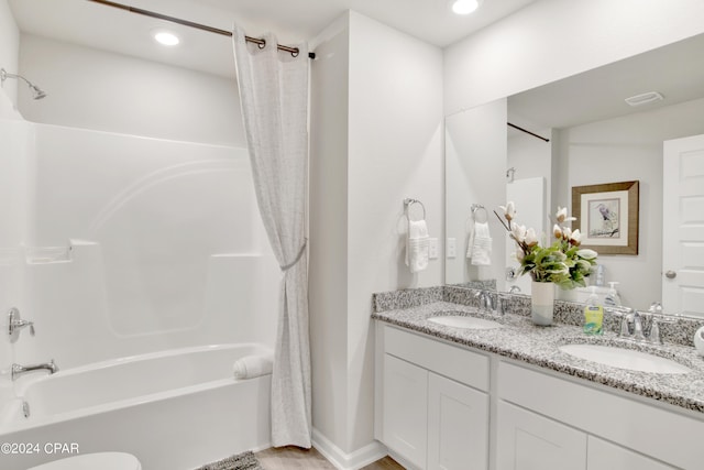 full bath featuring shower / tub combo, a sink, recessed lighting, and double vanity