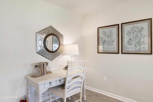 office area featuring baseboards and wood finished floors