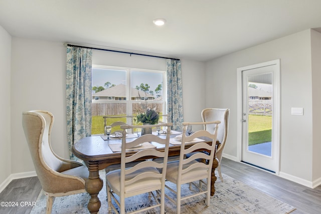 dining area featuring baseboards and wood finished floors