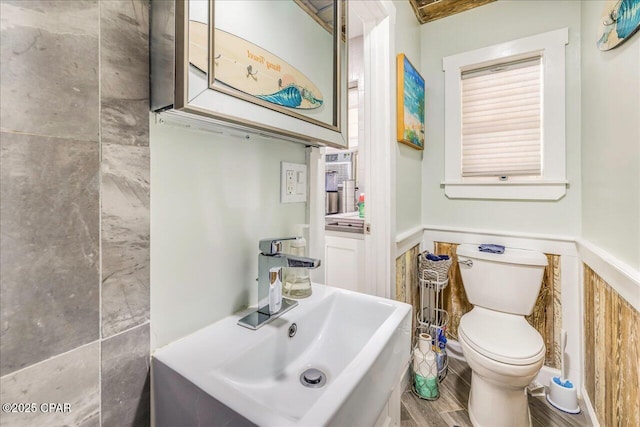 bathroom with sink, hardwood / wood-style floors, and toilet