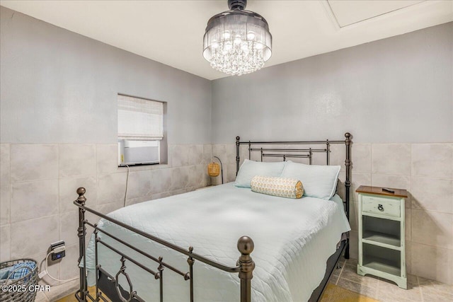 bedroom featuring tile patterned floors and tile walls