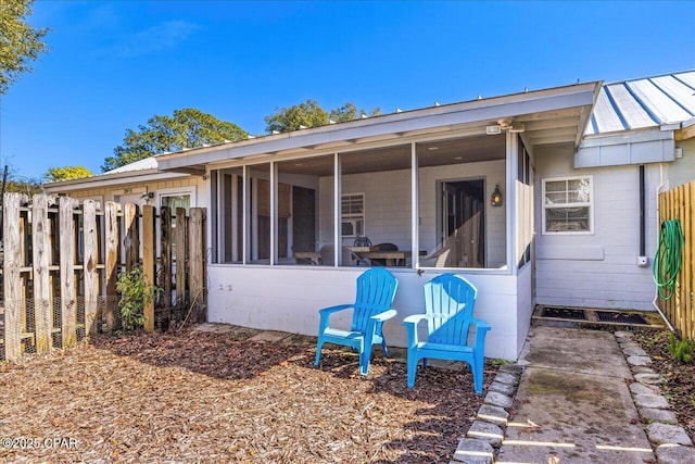 back of property featuring a sunroom