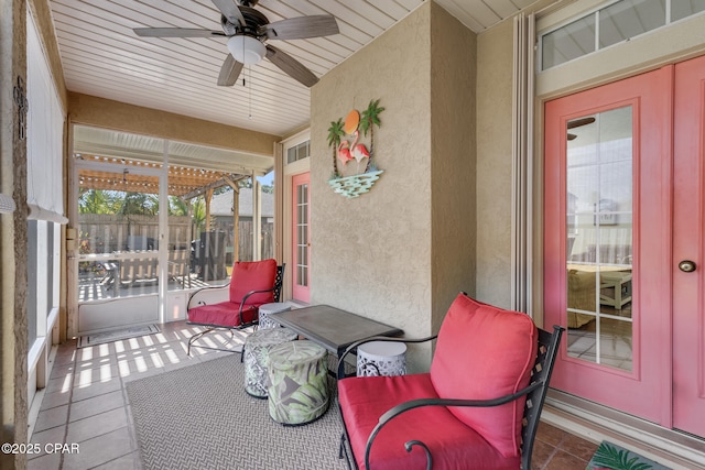 sunroom / solarium featuring ceiling fan