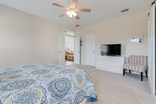 bedroom featuring ceiling fan and light colored carpet