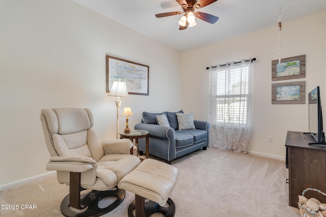 living area featuring ceiling fan and light colored carpet