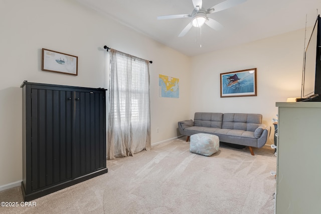 interior space with ceiling fan and light colored carpet