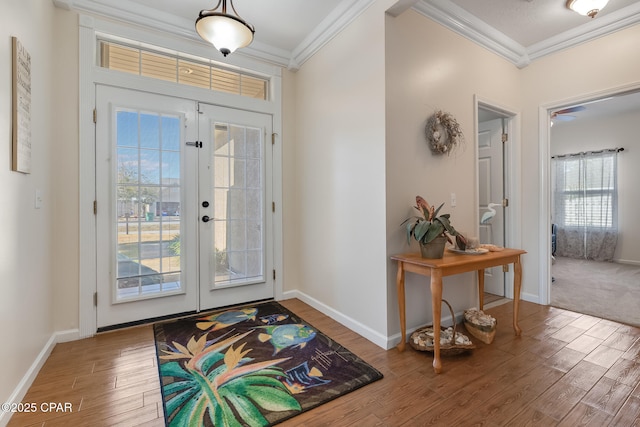 entrance foyer with hardwood / wood-style flooring, ornamental molding, and french doors