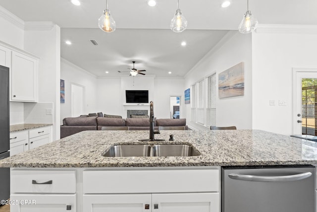 kitchen featuring visible vents, appliances with stainless steel finishes, crown molding, a fireplace, and a sink