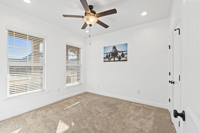 carpeted empty room with recessed lighting, a ceiling fan, and baseboards