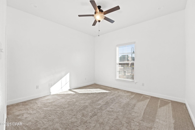 empty room featuring a ceiling fan, baseboards, and carpet flooring