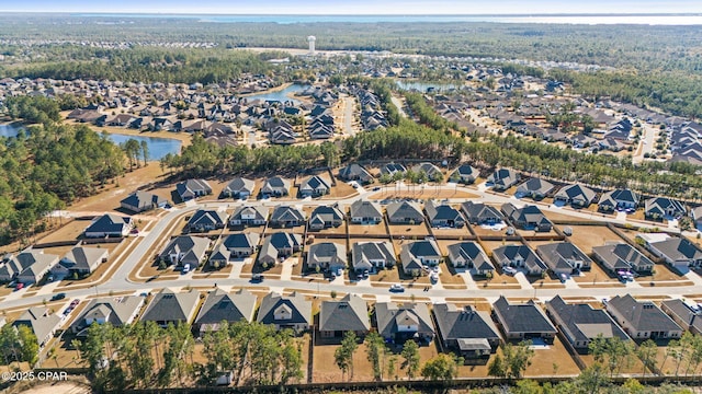 drone / aerial view featuring a residential view and a water view