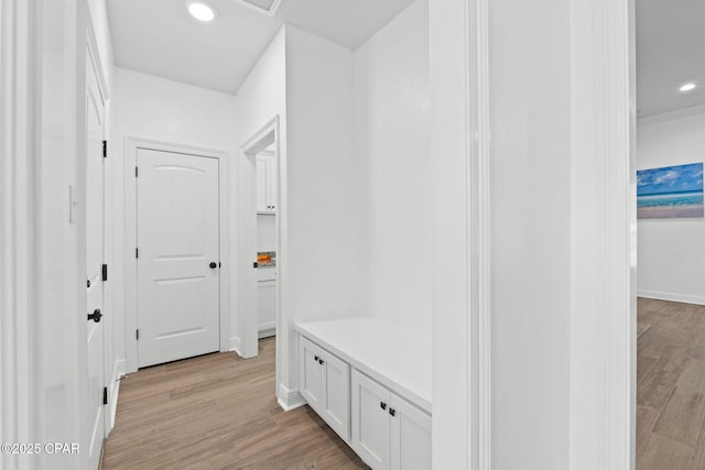 mudroom featuring light wood-style floors, baseboards, and recessed lighting