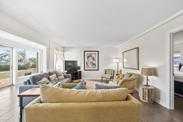 living room with dark wood-type flooring and a textured ceiling