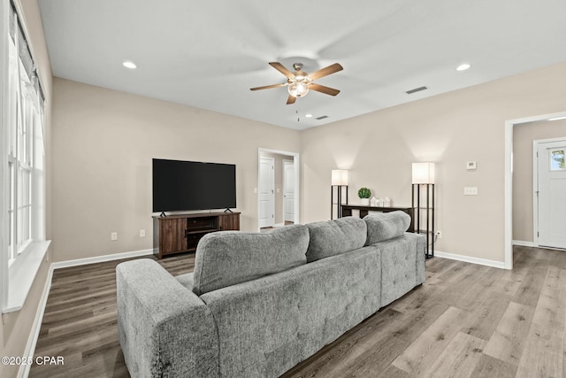 living room featuring ceiling fan and light wood-type flooring