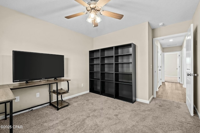 office space with ceiling fan and light colored carpet