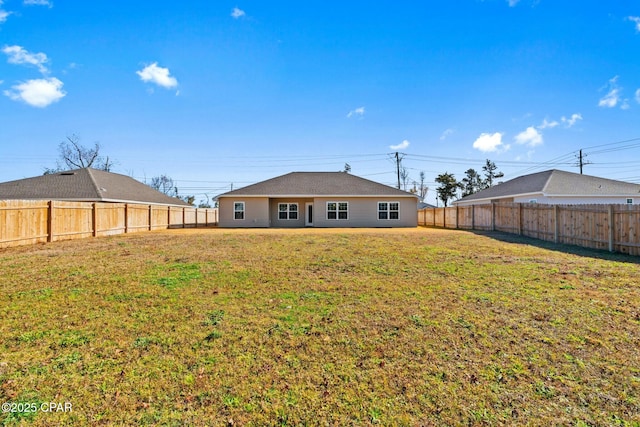 rear view of house with a lawn