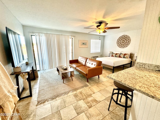 bedroom featuring ceiling fan and a textured ceiling