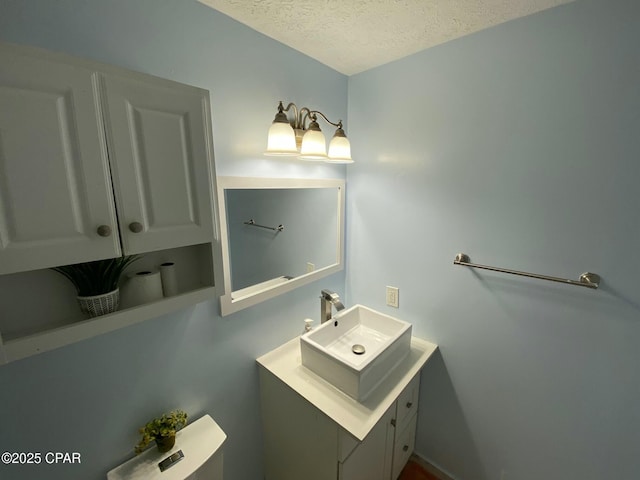 bathroom featuring vanity and a textured ceiling