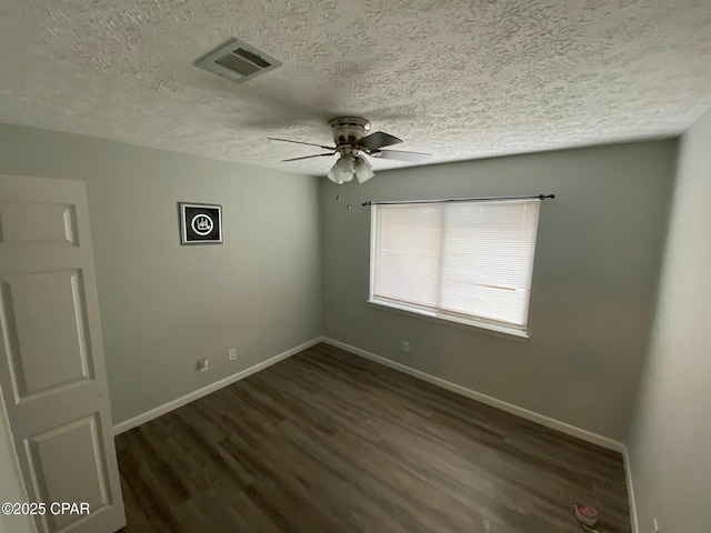 spare room with ceiling fan, dark hardwood / wood-style floors, and a textured ceiling