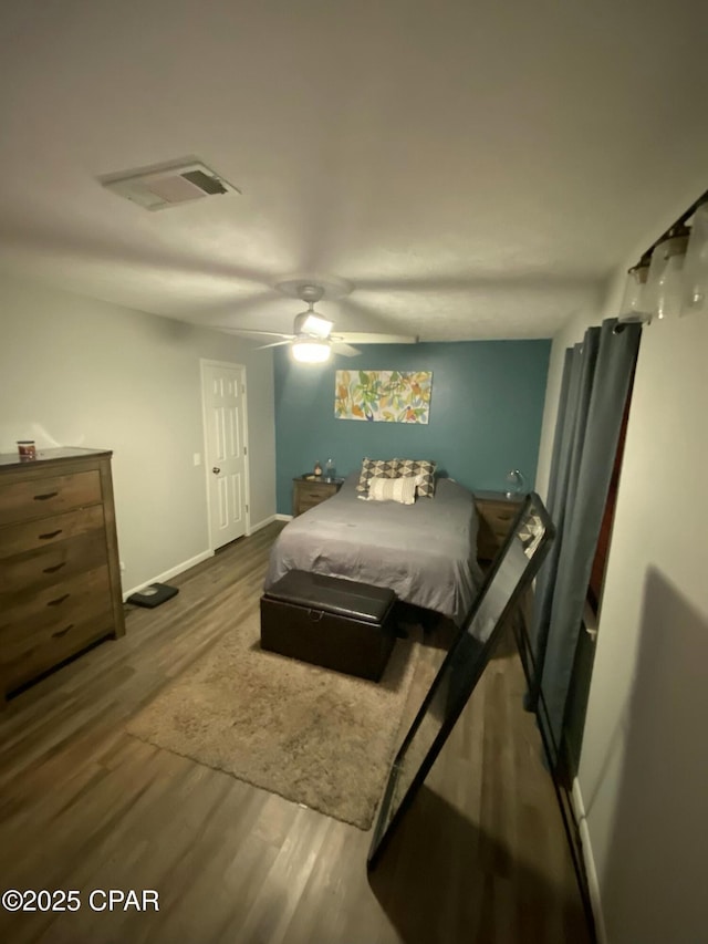 bedroom with hardwood / wood-style floors and ceiling fan