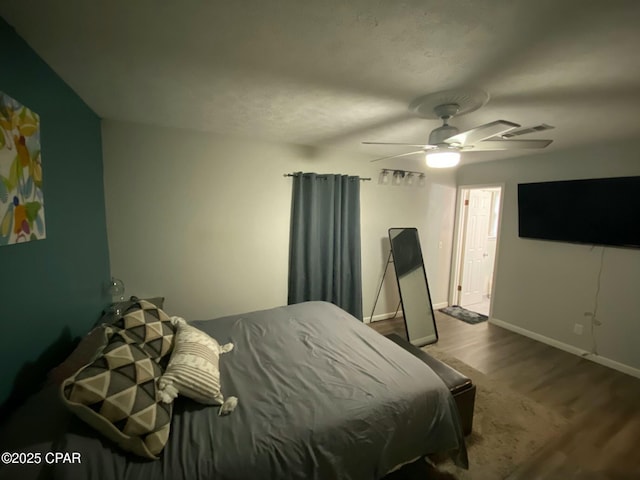 bedroom featuring ceiling fan and hardwood / wood-style flooring