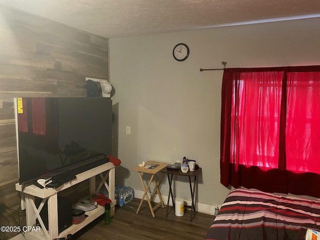 living room featuring dark wood-type flooring and a textured ceiling