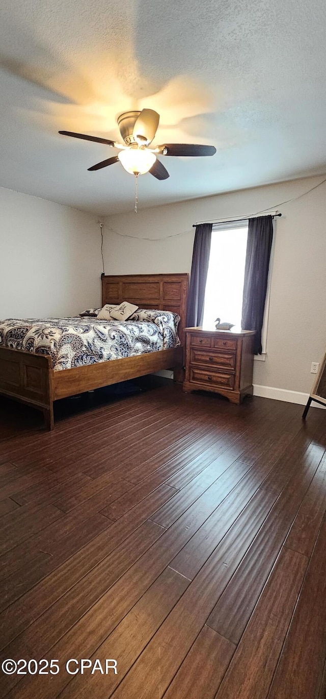 unfurnished bedroom featuring ceiling fan, a textured ceiling, and dark hardwood / wood-style floors