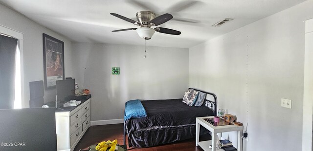 bedroom featuring dark hardwood / wood-style floors and ceiling fan