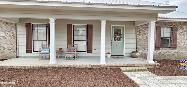 view of exterior entry with a porch