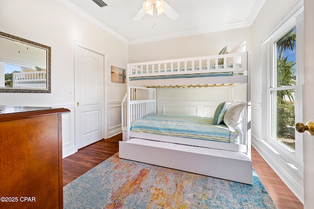 bedroom featuring ornamental molding, dark hardwood / wood-style floors, and ceiling fan