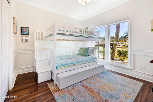 bedroom featuring crown molding, dark wood-type flooring, and ceiling fan