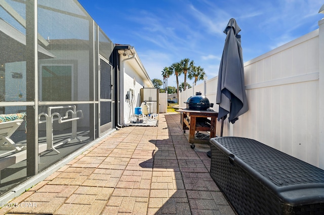 view of patio with glass enclosure