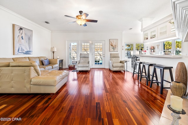 living room with crown molding, dark hardwood / wood-style floors, and ceiling fan