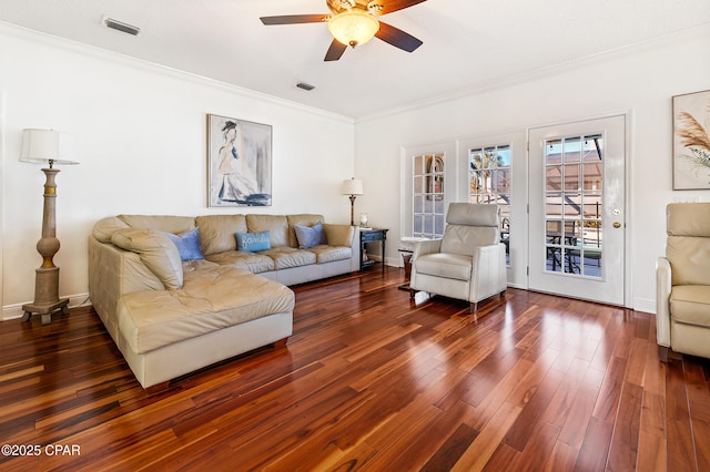 living room with crown molding, dark hardwood / wood-style floors, and ceiling fan