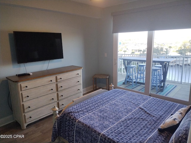 bedroom featuring access to outside, baseboards, and dark wood-type flooring