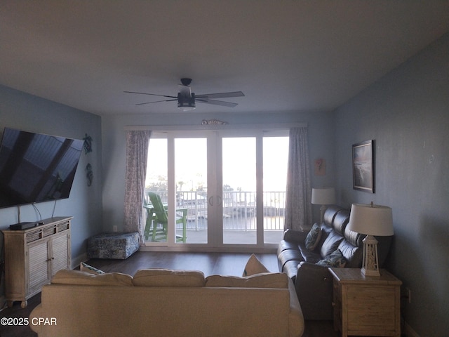 living area with a ceiling fan and wood finished floors