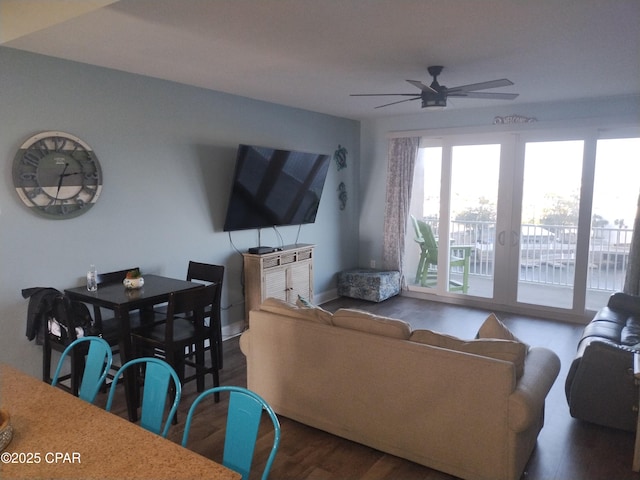 living area with ceiling fan and wood finished floors