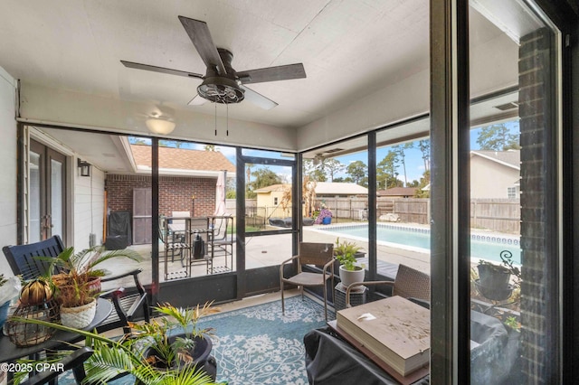 sunroom featuring ceiling fan