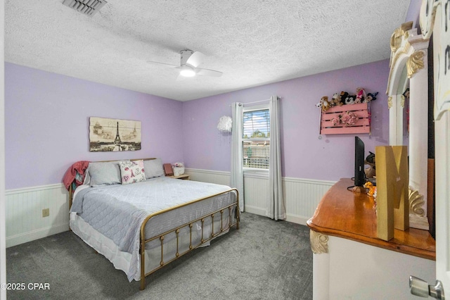 bedroom featuring ceiling fan, carpet, and a textured ceiling