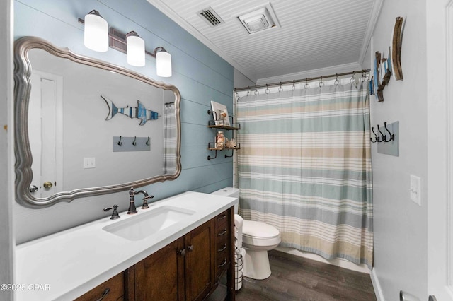 bathroom with hardwood / wood-style floors, vanity, ornamental molding, toilet, and wood walls