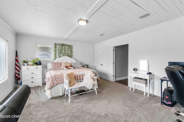 carpeted bedroom with beam ceiling, crown molding, and wood ceiling