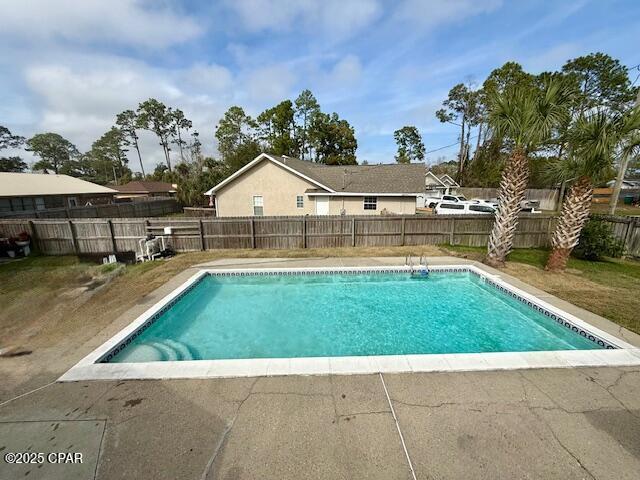 view of pool with a sunroom and a patio area