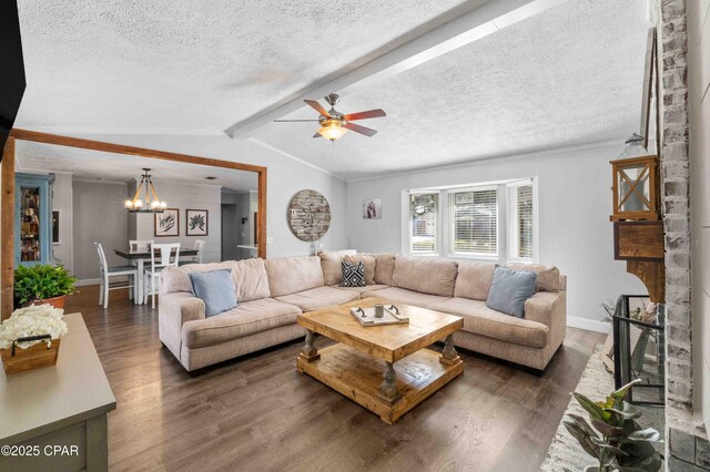 living room with dark hardwood / wood-style floors, a fireplace, lofted ceiling with beams, a textured ceiling, and ceiling fan with notable chandelier