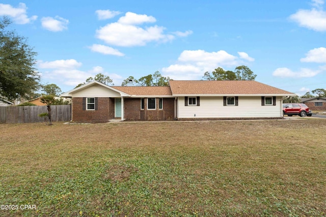 rear view of property with a yard