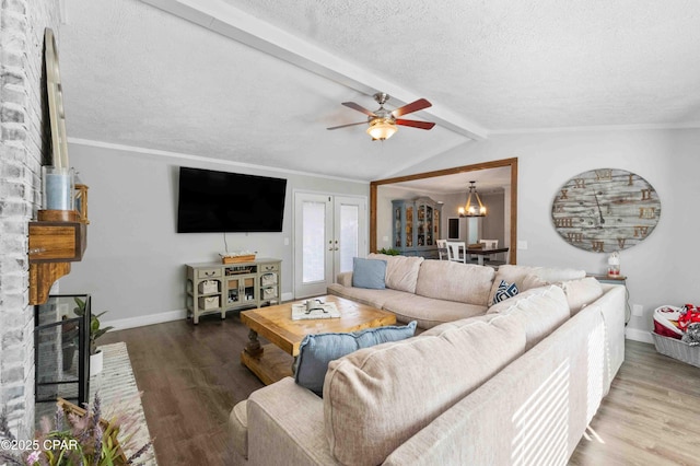 living room featuring hardwood / wood-style floors, a fireplace, french doors, and a textured ceiling