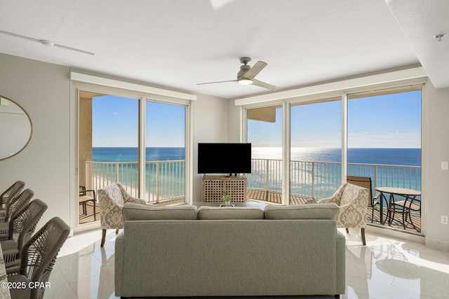 tiled living room featuring ceiling fan