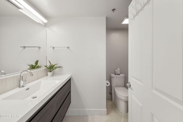 bathroom featuring toilet, vanity, and tile patterned flooring