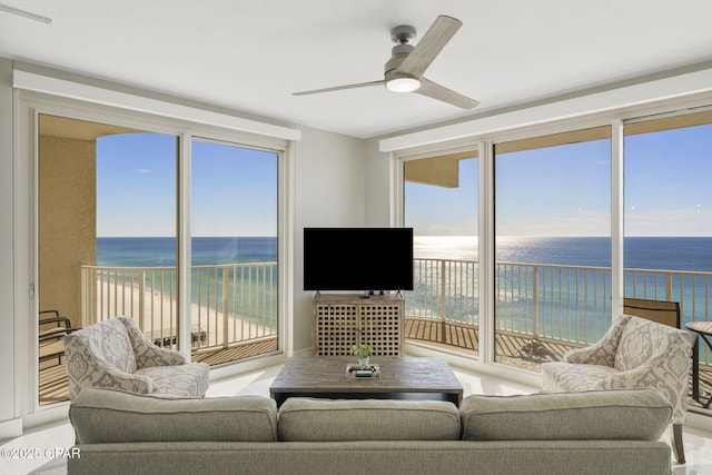 living room featuring ceiling fan and plenty of natural light