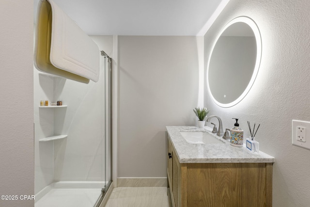 bathroom with an enclosed shower and vanity